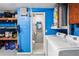 Bright laundry area with modern washer, dryer, utility sink, and access to a bathroom at 5321 Mosaic Dr, Holiday, FL 34690