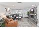 Open-concept living room featuring comfortable sofas, stylish decor, and natural light streaming through sheer curtains at 5321 Mosaic Dr, Holiday, FL 34690