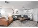 Bright living room with a large sofa, wood accents, and a stylish rug at 5321 Mosaic Dr, Holiday, FL 34690