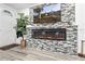 Inviting living room featuring a modern fireplace, large screen TV, and stylish decor at 5321 Mosaic Dr, Holiday, FL 34690