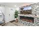Inviting living room featuring a modern fireplace, large screen TV, and stylish decor at 5321 Mosaic Dr, Holiday, FL 34690