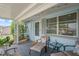 Inviting porch with comfortable seating, a glass table, and views of the front yard at 5321 Mosaic Dr, Holiday, FL 34690