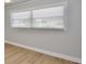A gray bedroom with light-colored floor with a window providing natural light at 5339 Bowline Bnd, New Port Richey, FL 34652