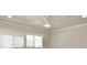 Bedroom featuring a ceiling fan and a large window with horizontal blinds at 5339 Bowline Bnd, New Port Richey, FL 34652