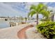 Beautiful waterfront view with a private dock and seating area, complete with lush landscaping and blue skies at 5339 Bowline Bnd, New Port Richey, FL 34652