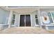 Close up of the stately double front door of the home and sidelight windows at 5339 Bowline Bnd, New Port Richey, FL 34652