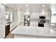 Bright kitchen featuring white cabinets, stainless steel appliances, and a large center island with ample counter space at 5339 Bowline Bnd, New Port Richey, FL 34652