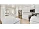 Modern kitchen boasts white cabinetry, stainless steel appliances, a spacious island, and sleek countertops at 5339 Bowline Bnd, New Port Richey, FL 34652
