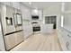 A modern kitchen with stainless steel appliances, white cabinets, and bright flooring at 5339 Bowline Bnd, New Port Richey, FL 34652