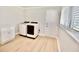 Bright laundry room with a modern washer and dryer, laminate floors, and natural light at 5339 Bowline Bnd, New Port Richey, FL 34652