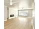 Spacious living room with light floors, recessed lighting, and a modern fireplace creates a cozy, inviting atmosphere at 5339 Bowline Bnd, New Port Richey, FL 34652