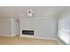 Bright living room boasts a modern fireplace, light hardwood floors, fresh paint, and a well-lit window at 5339 Bowline Bnd, New Port Richey, FL 34652