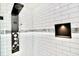 Shower with a contemporary shower panel, niche, and white subway tile at 5339 Bowline Bnd, New Port Richey, FL 34652