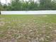 Large, private backyard featuring healthy grass, great for outdoor activities, with white fence at 5373 Frost Rd, Spring Hill, FL 34606