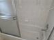 Clean bathtub with shower head and sliding glass door, perfect for relaxation at 5373 Frost Rd, Spring Hill, FL 34606