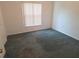 Empty bedroom with neutral walls, comfortable carpet, and a bright window at 5373 Frost Rd, Spring Hill, FL 34606