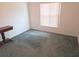Cozy bedroom featuring soft carpet, neutral walls, and a bright window with natural light at 5373 Frost Rd, Spring Hill, FL 34606