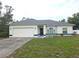 Charming single-story home featuring a two-car garage and tidy front yard with lawn at 5373 Frost Rd, Spring Hill, FL 34606