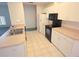 Efficient kitchen with white cabinets, neutral countertops, and standard appliances at 5373 Frost Rd, Spring Hill, FL 34606