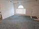 Inviting living room with large window, neutral carpet, and ample natural light at 5373 Frost Rd, Spring Hill, FL 34606