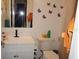 Well-lit bathroom with modern fixtures, a shower, and playful butterfly decor at 5434 Chad Pl # 14, New Port Richey, FL 34652