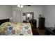 Cozy bedroom with bright, patterned quilt, wood furniture, and inviting natural light at 5434 Chad Pl # 14, New Port Richey, FL 34652