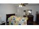 Bright bedroom with patterned quilt, wood furniture, and plenty of natural light at 5434 Chad Pl # 14, New Port Richey, FL 34652