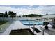 Community pool area featuring a swimming pool, fountain, and white picket fencing at 5434 Chad Pl # 14, New Port Richey, FL 34652