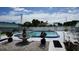 Community pool area featuring a swimming pool, fountain, and white picket fencing at 5434 Chad Pl # 14, New Port Richey, FL 34652