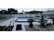 Community pool area featuring a swimming pool, fountain, and white picket fencing at 5434 Chad Pl # 14, New Port Richey, FL 34652