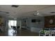 Large recreation room with tables, chairs, a kitchen area, and stone accent wall at 5434 Chad Pl # 14, New Port Richey, FL 34652