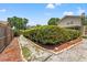 Well-maintained backyard with trimmed hedges and stone lined garden bed at 5502 Bluejay Ln, Tampa, FL 33625