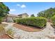Landscaped backyard featuring hedges, white stone and a garden bed at 5502 Bluejay Ln, Tampa, FL 33625