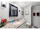 Bathroom with granite countertop, black framed mirror, and red towels at 5502 Bluejay Ln, Tampa, FL 33625