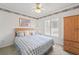 Bedroom featuring a ceiling fan with floral trim and plantation shutters at 5502 Bluejay Ln, Tampa, FL 33625