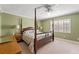 Spacious bedroom with a four poster bed, ceiling fan, and plantation shutters at 5502 Bluejay Ln, Tampa, FL 33625