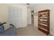 Bedroom featuring a closet, shelving unit, and doorway to a bathroom at 5502 Bluejay Ln, Tampa, FL 33625