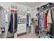 Walk-in closet with custom shelving and clothes hanging at 5502 Bluejay Ln, Tampa, FL 33625