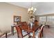 Formal dining area with elegant wood table, chandelier, and comfortable seating for sophisticated meals at 5502 Bluejay Ln, Tampa, FL 33625