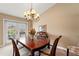 Dining space with patio access, wooden table set, and a chandelier, perfect for Gathering meals and entertaining at 5502 Bluejay Ln, Tampa, FL 33625