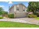 Two-story home boasts a two-car garage, stone accents, and a neatly maintained front yard at 5502 Bluejay Ln, Tampa, FL 33625