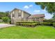 Two-story home with stone accents and a well-manicured lawn under a sunny blue sky at 5502 Bluejay Ln, Tampa, FL 33625