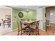 Quaint eat-in kitchen with stylish wood chairs, unique flooring, and open doorway at 5502 Bluejay Ln, Tampa, FL 33625
