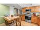 Cozy kitchen nook with tile-top table, stainless steel appliances, and warm wood cabinets at 5502 Bluejay Ln, Tampa, FL 33625