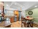 Well-lit kitchen with breakfast table, stainless steel appliances, granite countertops, and ample cabinet space at 5502 Bluejay Ln, Tampa, FL 33625