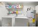 Laundry room with washer, dryer, shelving, and a hot water tank at 5502 Bluejay Ln, Tampa, FL 33625
