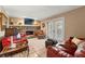 Comfortable living room featuring a stone fireplace, tile flooring, and access to the outdoors at 5502 Bluejay Ln, Tampa, FL 33625