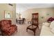 Cozy living room featuring a dining table set, stylish cabinet, comfortable seating, and neutral décor at 5502 Bluejay Ln, Tampa, FL 33625
