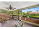 Patio featuring rocking chairs, wood flooring, and screened-in views of the backyard at 5502 Bluejay Ln, Tampa, FL 33625
