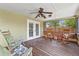 Relaxing screened-in patio with rocking chairs and wood flooring at 5502 Bluejay Ln, Tampa, FL 33625
